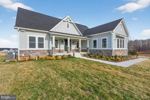 a front view of a house with a big yard