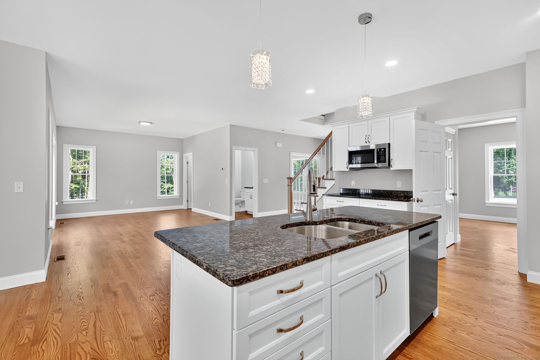 43 Wyllys Farm Road Storrs Mansfield, CT 06268 - Photo 11 of 40 a kitchen with granite countertop a sink a stove cabinets and wooden floor