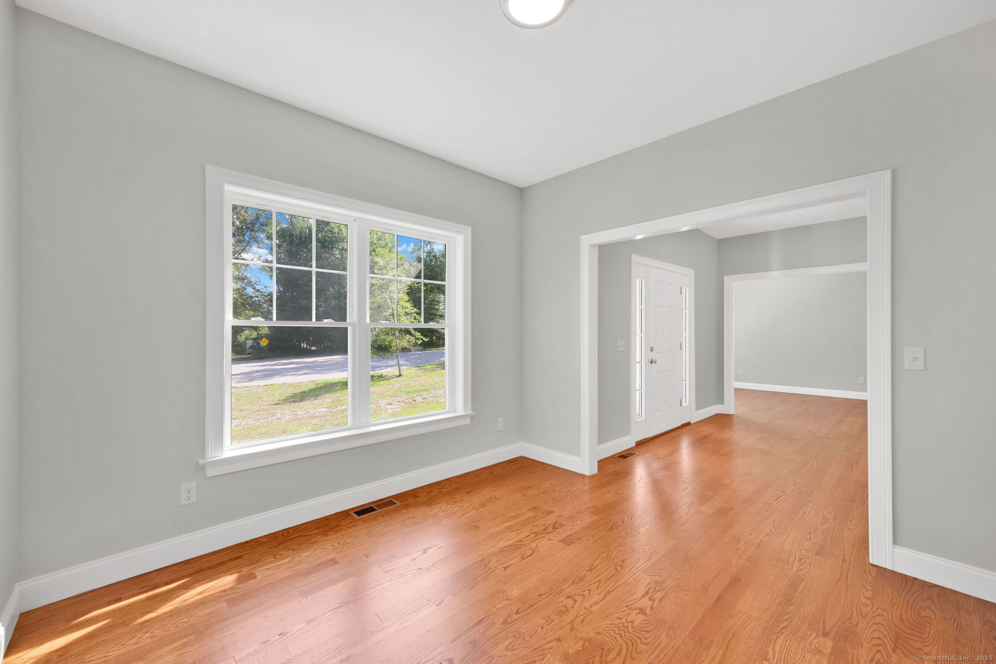 43 Wyllys Farm Road Storrs Mansfield, CT 06268 - Photo 20 of 40 a view of an empty room with wooden floor and a window
