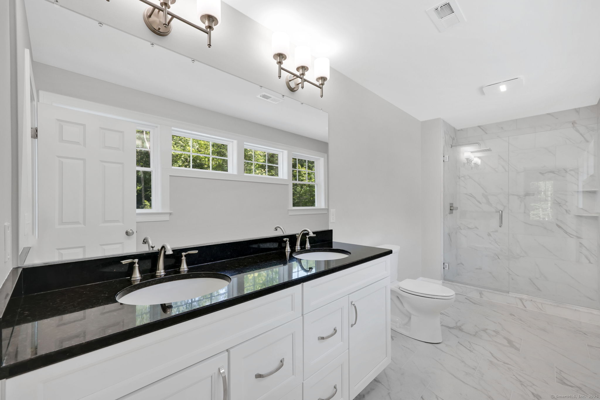43 Wyllys Farm Road Storrs Mansfield, CT 06268 - Photo 26 of 40 a bathroom with a granite countertop sink a toilet a mirror and shower