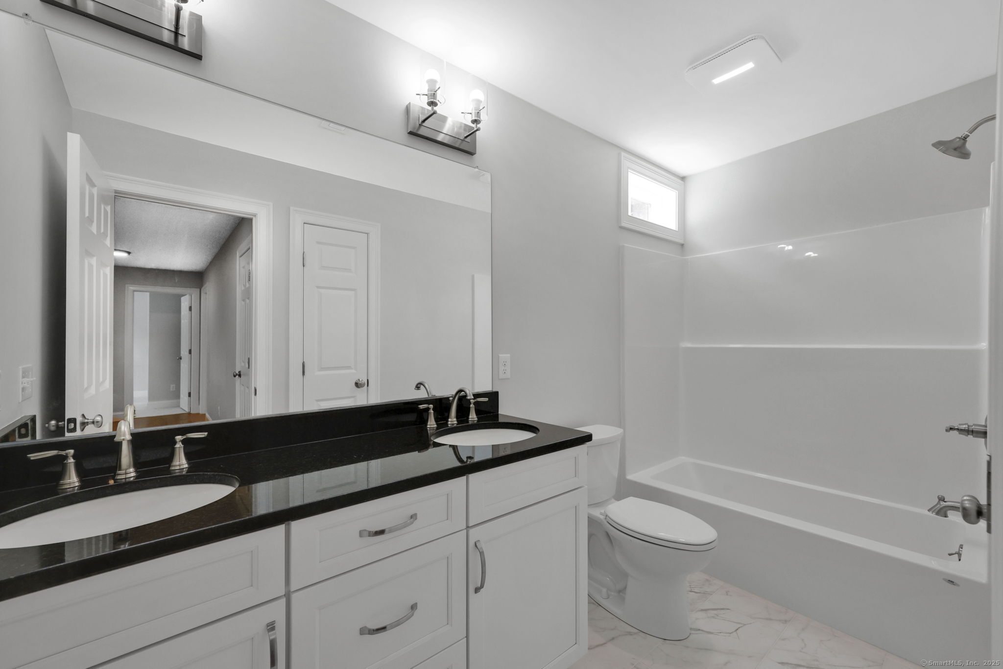 43 Wyllys Farm Road Storrs Mansfield, CT 06268 - Photo 35 of 40 a bathroom with a granite countertop sink a toilet a mirror and shower