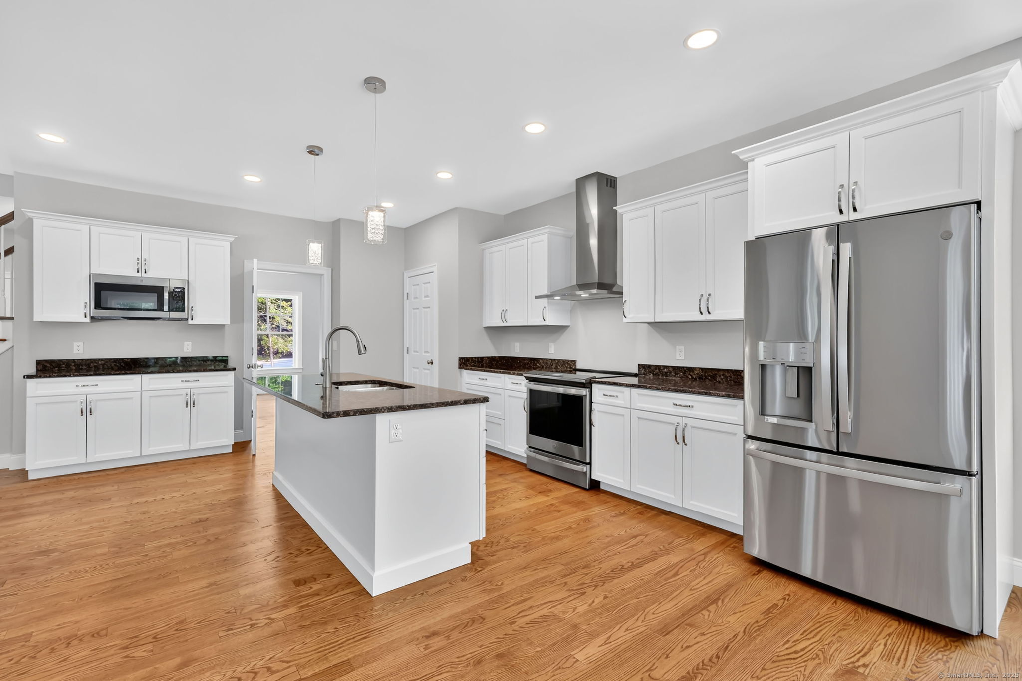 43 Wyllys Farm Road Storrs Mansfield, CT 06268 - Photo 8 of 40 a large kitchen with stainless steel appliances and white cabinets