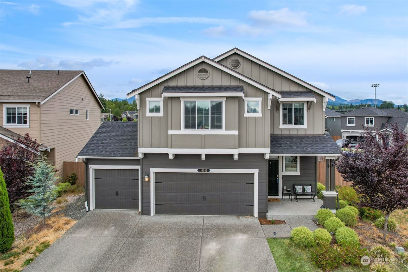 10305 Messner Avenue Granite Falls, WA 98252 - Photo 1 of 23 a front view of a house with a yard and garage