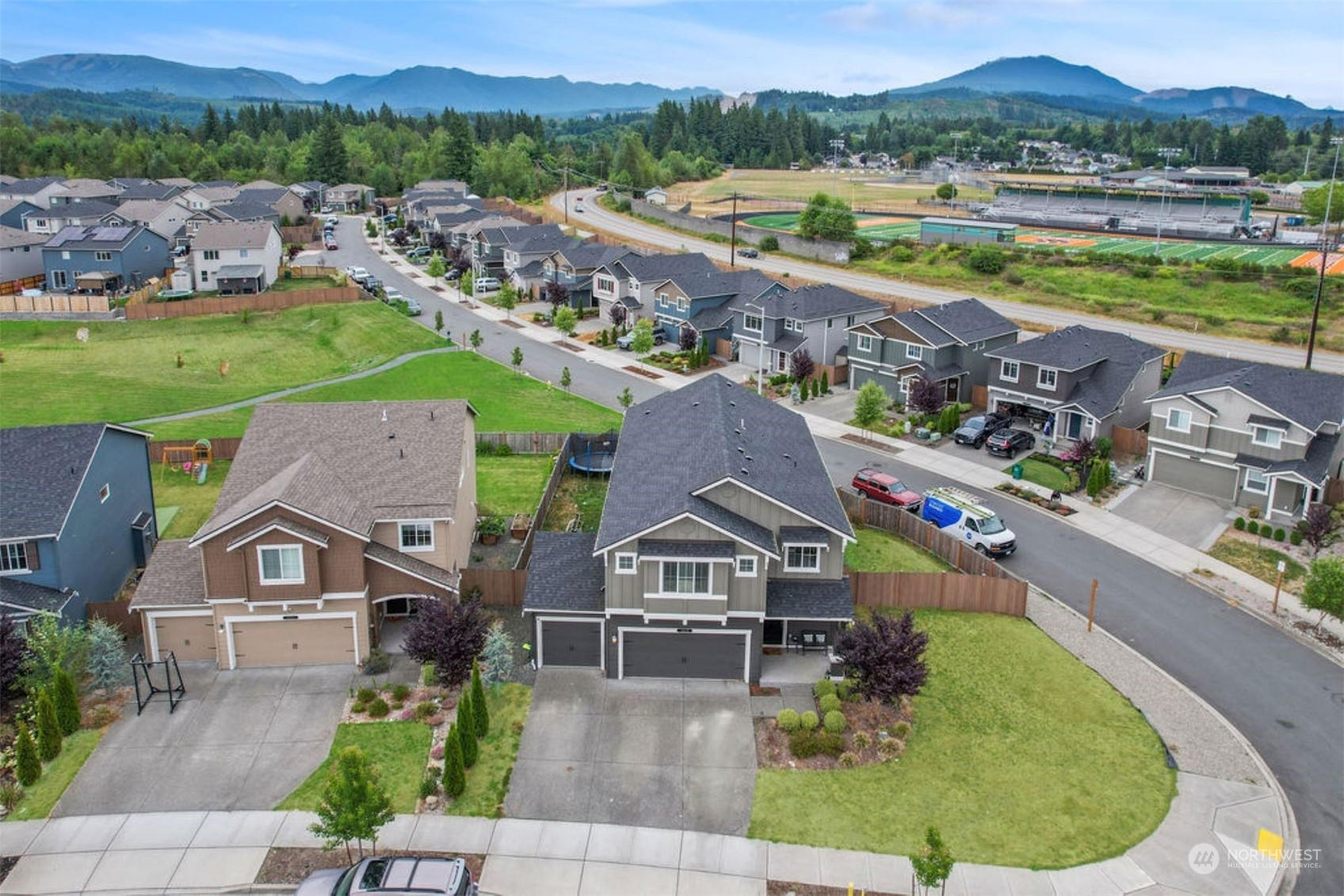10305 Messner Avenue Granite Falls, WA 98252 - Photo 3 of 23 an aerial view of a house with outdoor space swimming pool and mountains