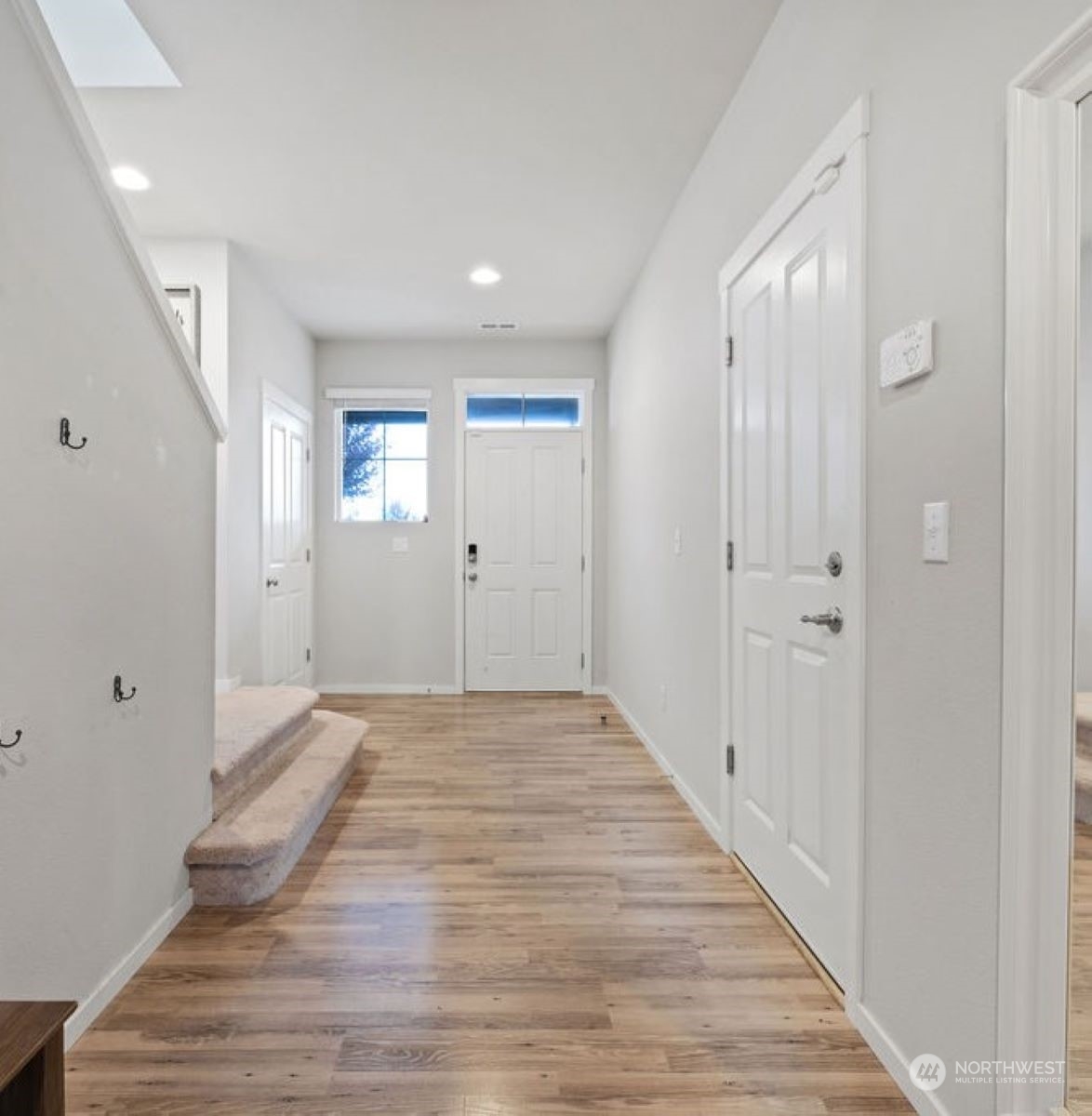 10305 Messner Avenue Granite Falls, WA 98252 - Photo 5 of 23 a view of a hallway with wooden floor and a bathroom