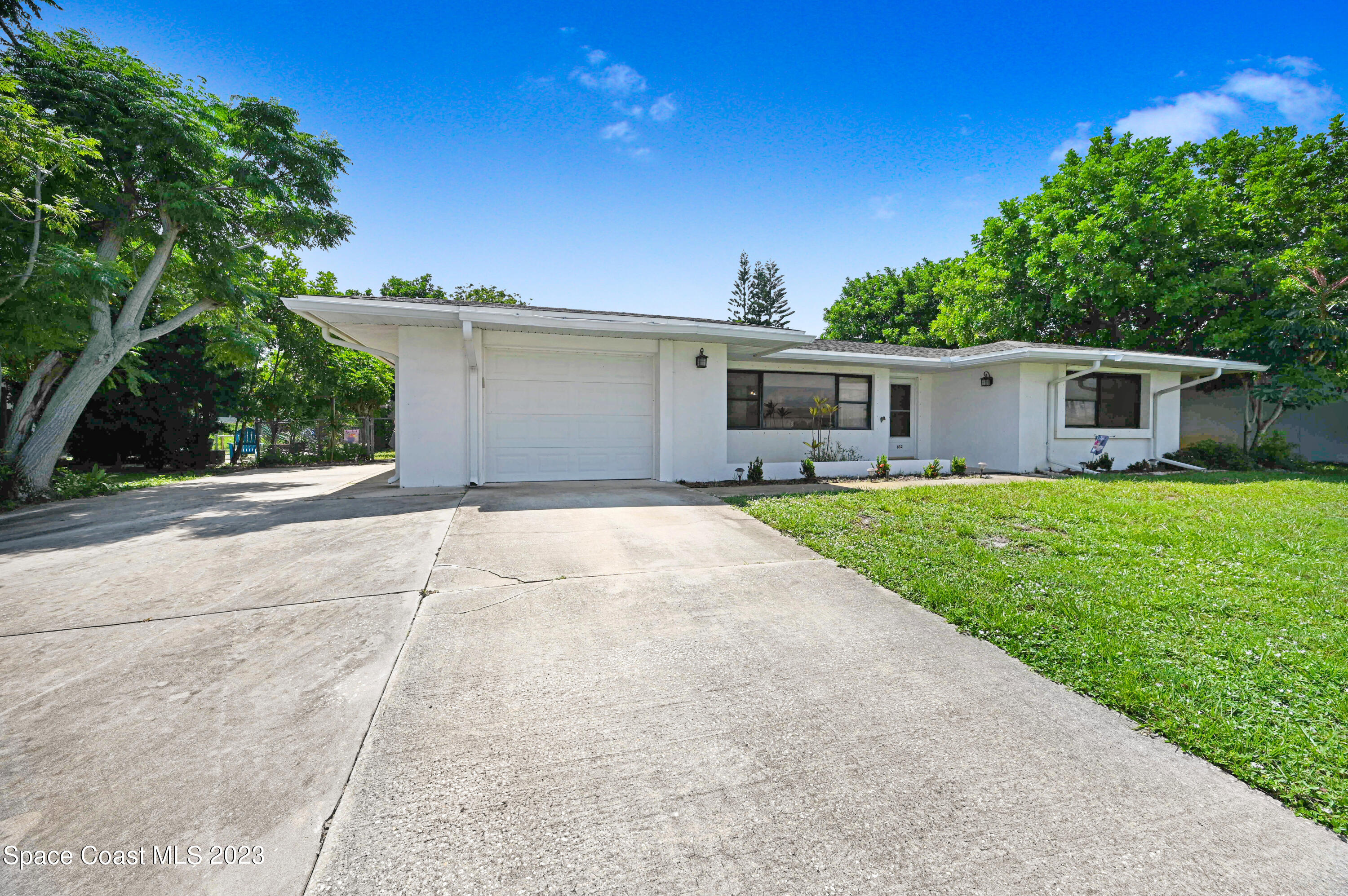 a front view of house with yard and green space