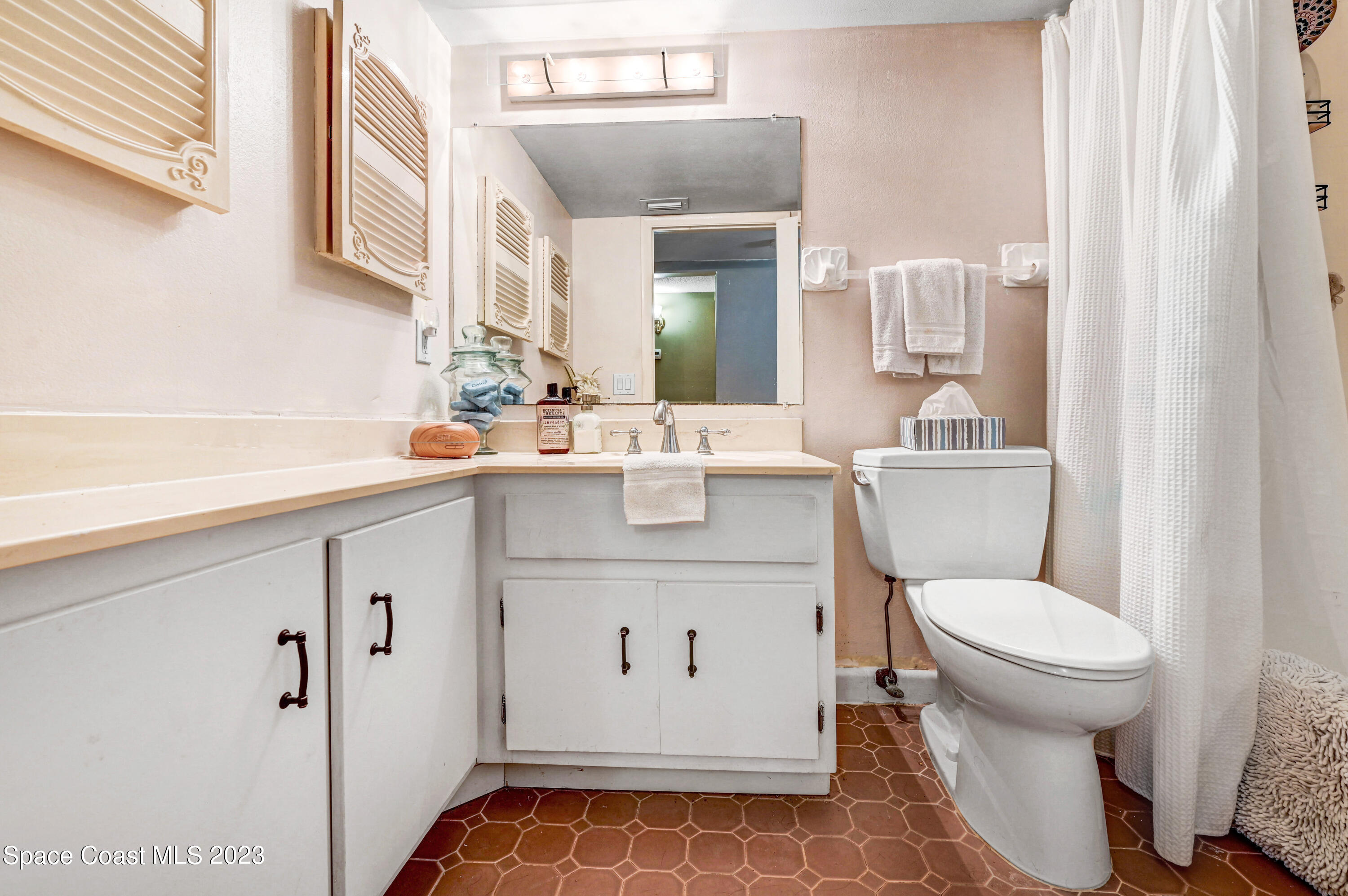 832 Damask Street Northeast Palm Bay, FL 32905 - Photo 14 of 18 a white toilet sitting next to a bathroom sink