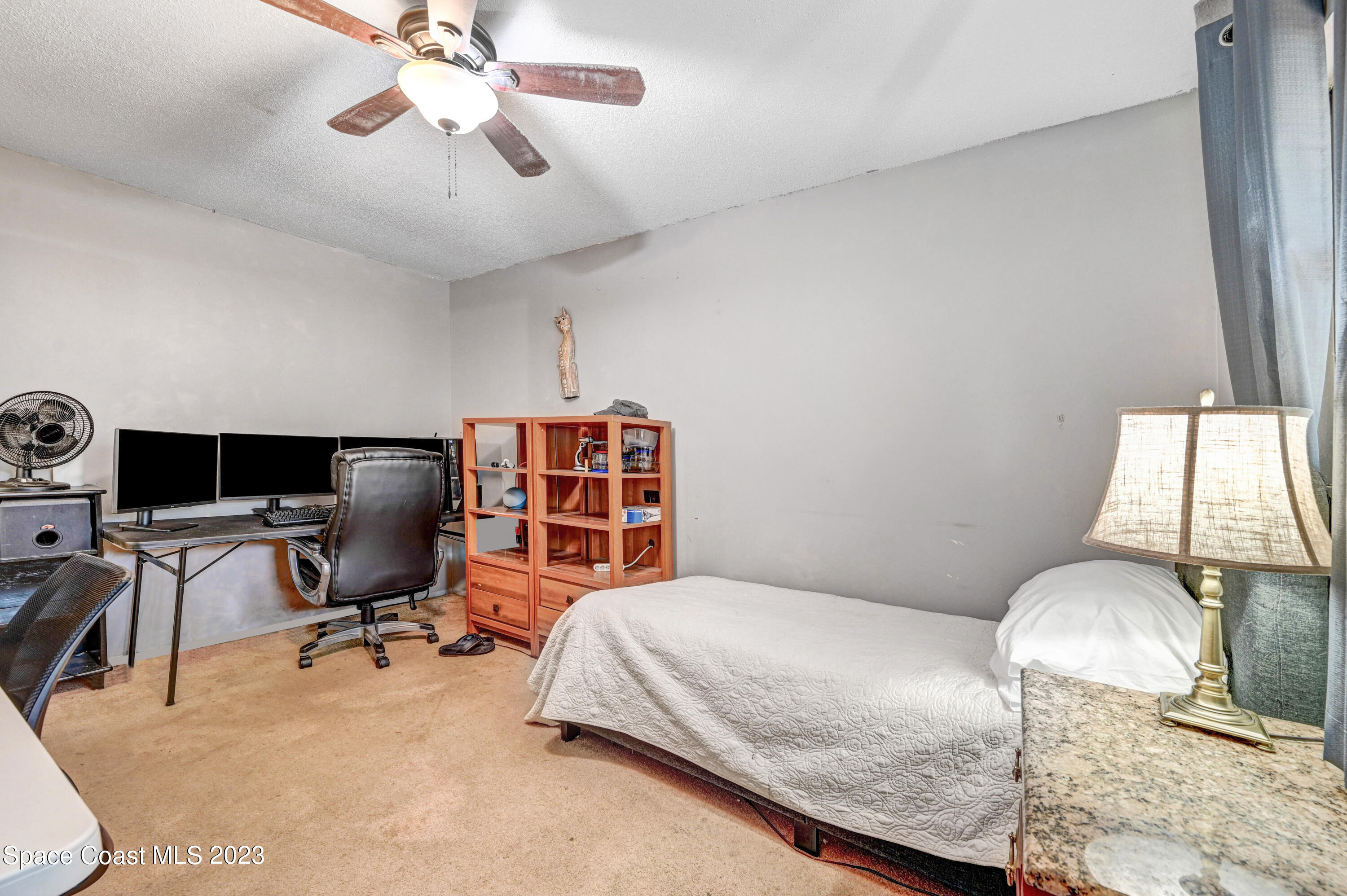 832 Damask Street Northeast Palm Bay, FL 32905 - Photo 15 of 18 a bedroom with a workspace