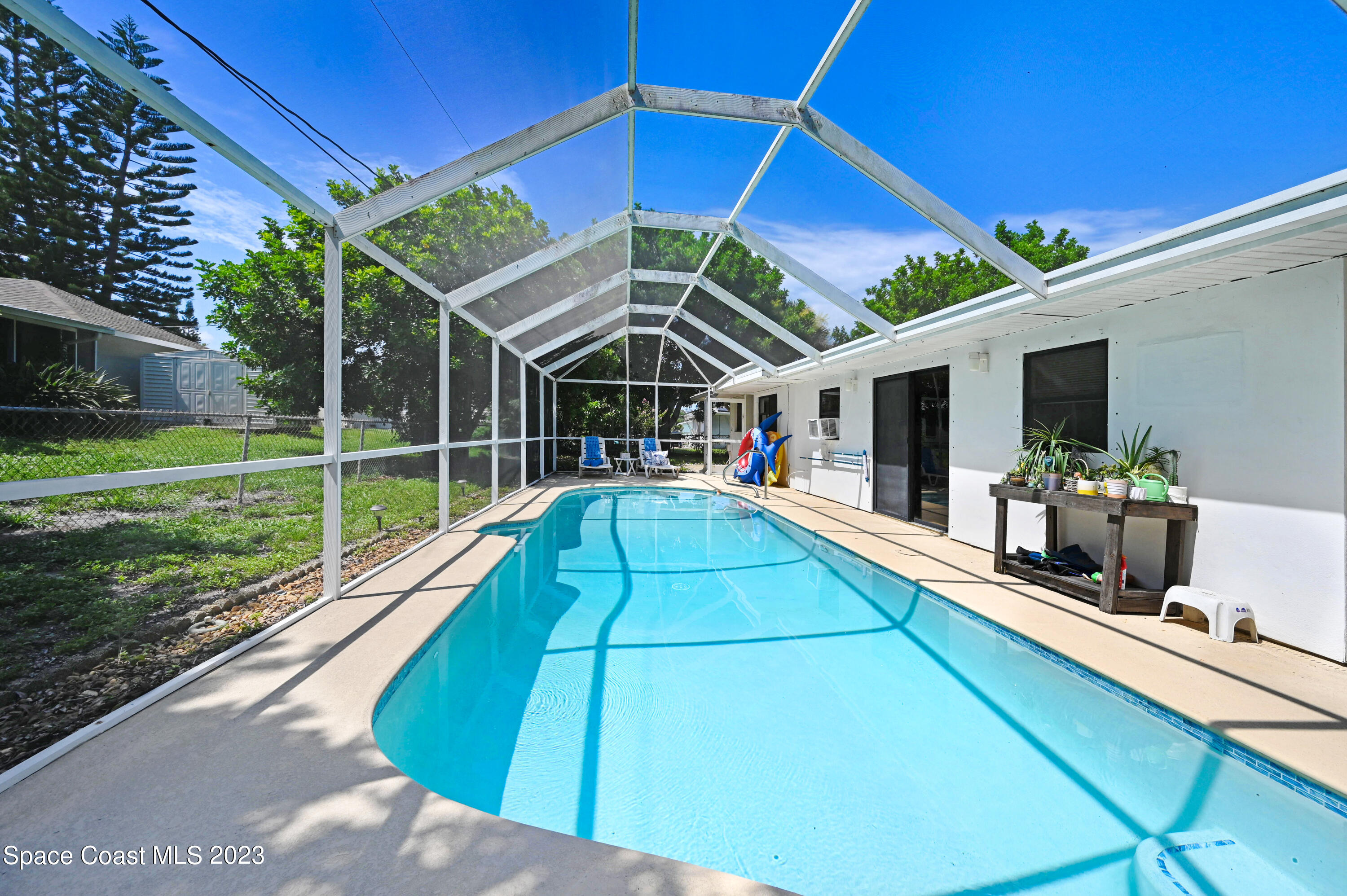 832 Damask Street Northeast Palm Bay, FL 32905 - Photo 18 of 18 a view of a backyard with a patio and plants