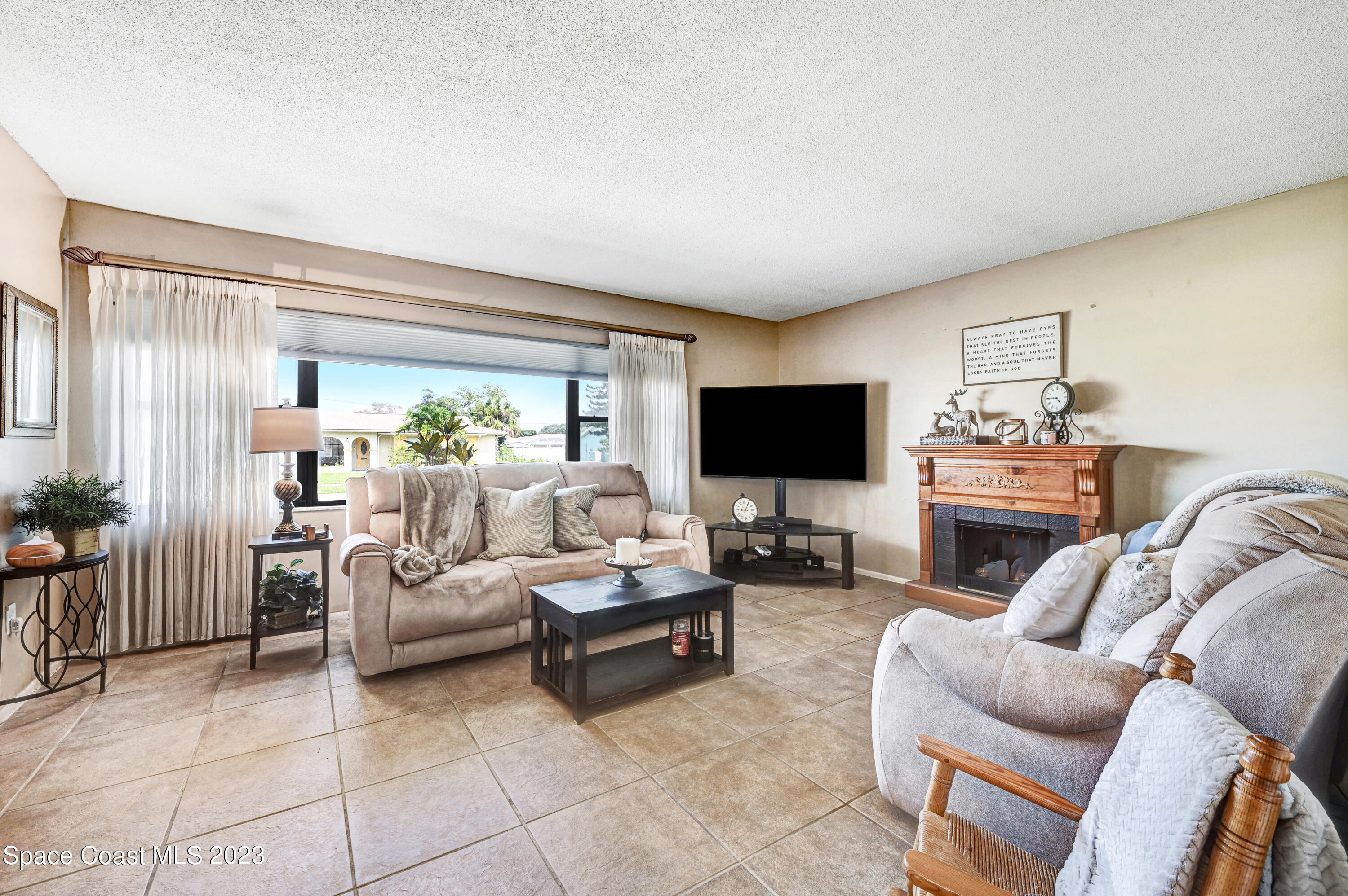 832 Damask Street Northeast Palm Bay, FL 32905 - Photo 3 of 18 a living room with furniture and a flat screen tv