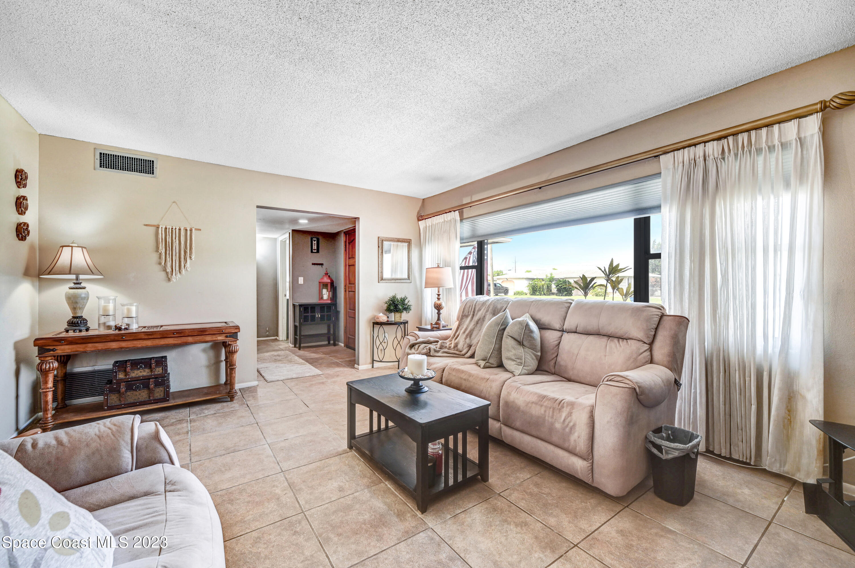 832 Damask Street Northeast Palm Bay, FL 32905 - Photo 4 of 18 a living room with furniture and a fireplace