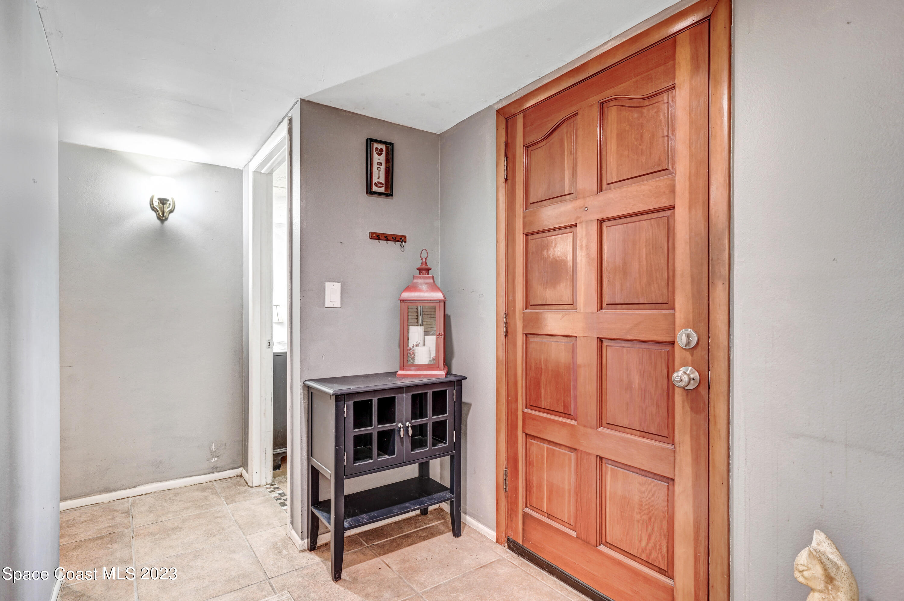832 Damask Street Northeast Palm Bay, FL 32905 - Photo 5 of 18 a view of front door with hallway