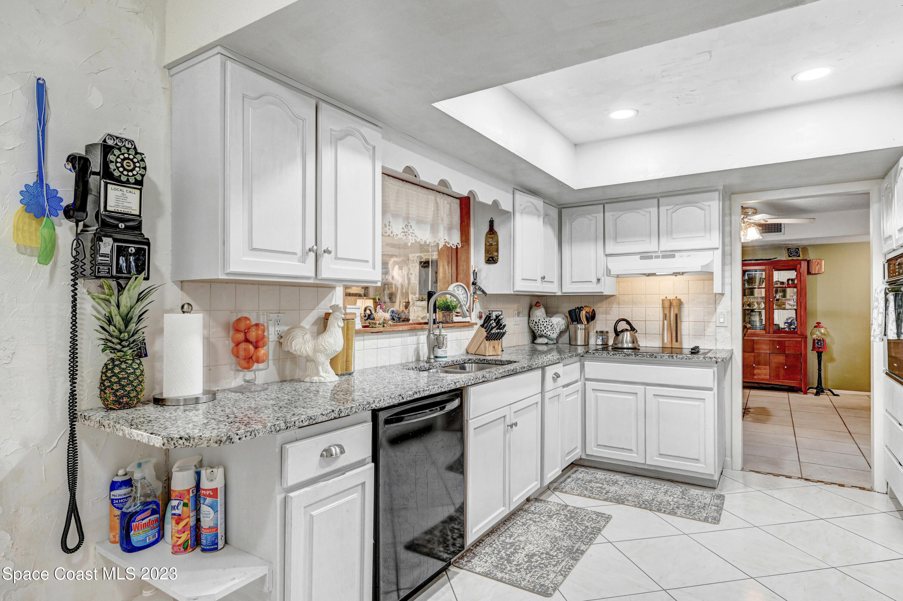 832 Damask Street Northeast Palm Bay, FL 32905 - Photo 7 of 18 a kitchen with stainless steel appliances granite countertop a sink and cabinets