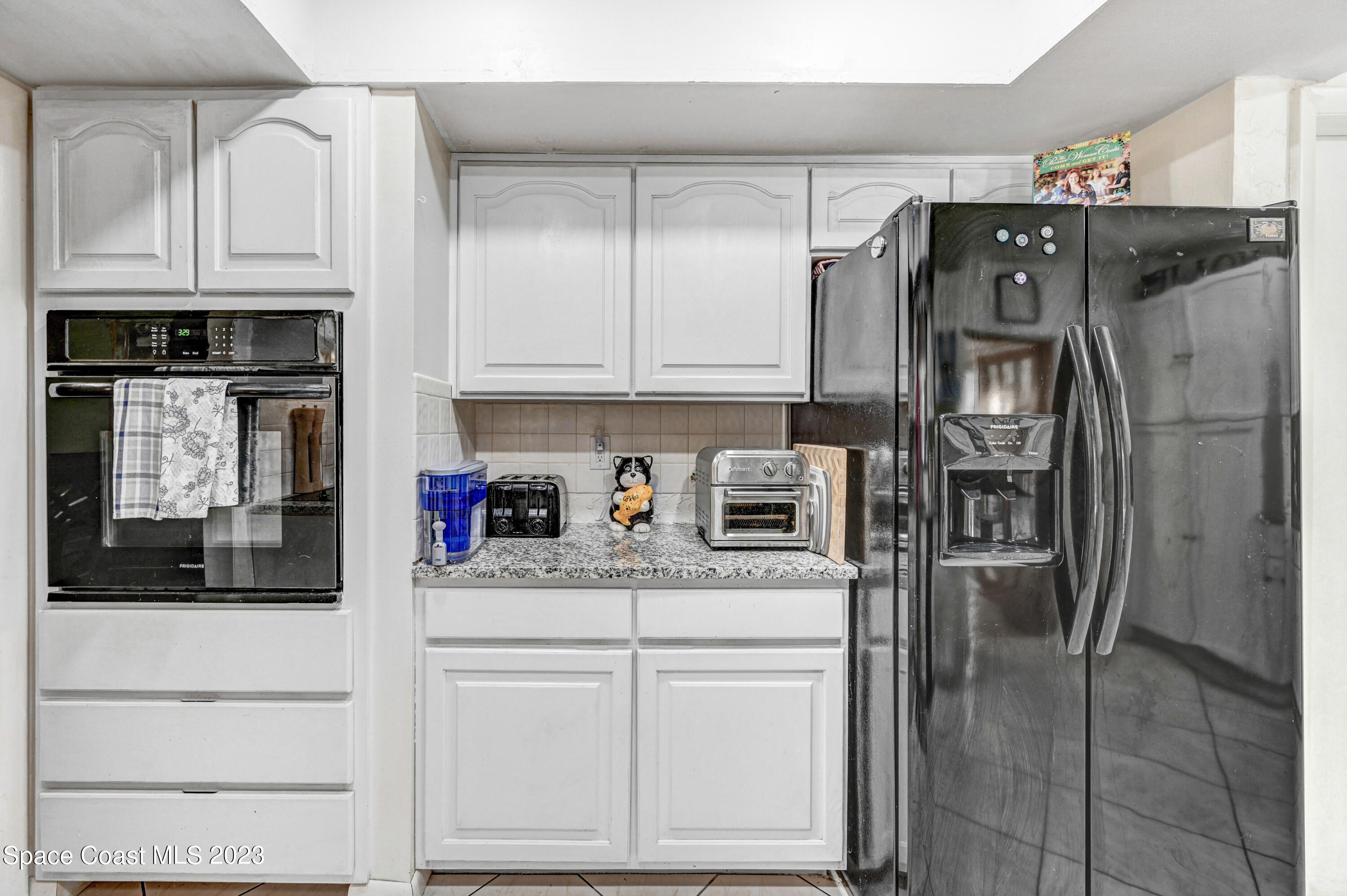 832 Damask Street Northeast Palm Bay, FL 32905 - Photo 9 of 18 a kitchen with stainless steel appliances granite countertop a refrigerator and a stove