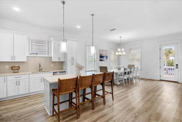 a large kitchen with cabinets table and chairs