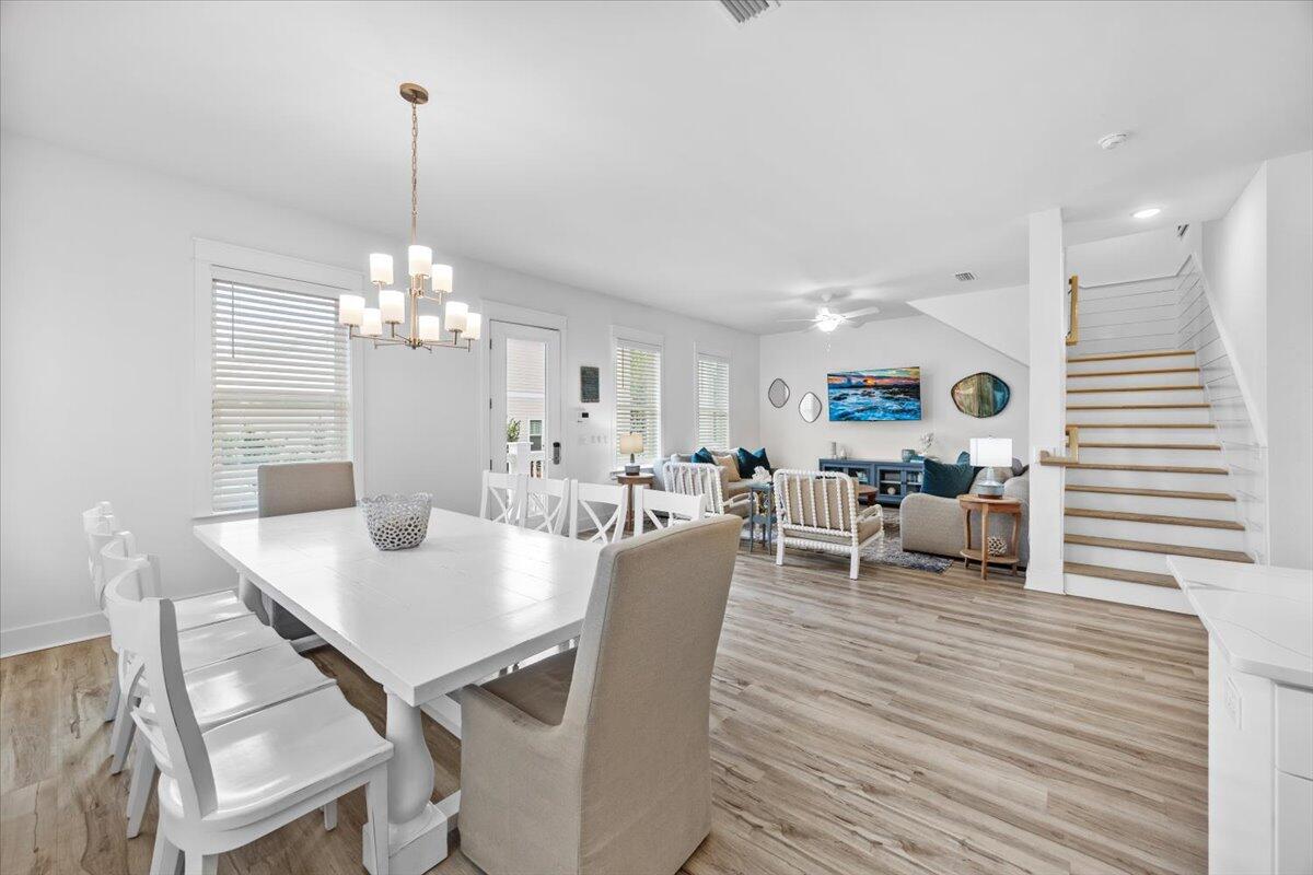 12 Caba Cove Santa Rosa Beach, FL 32459 - Photo 9 of 37 a view of a dining room and livingroom with furniture wooden floor a chandelier
