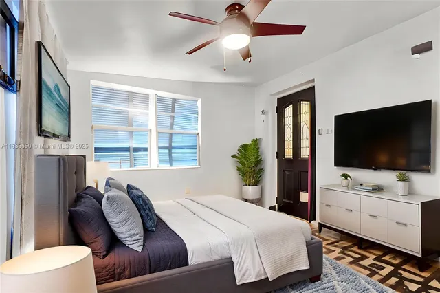 a bedroom with a bed and a flat screen tv