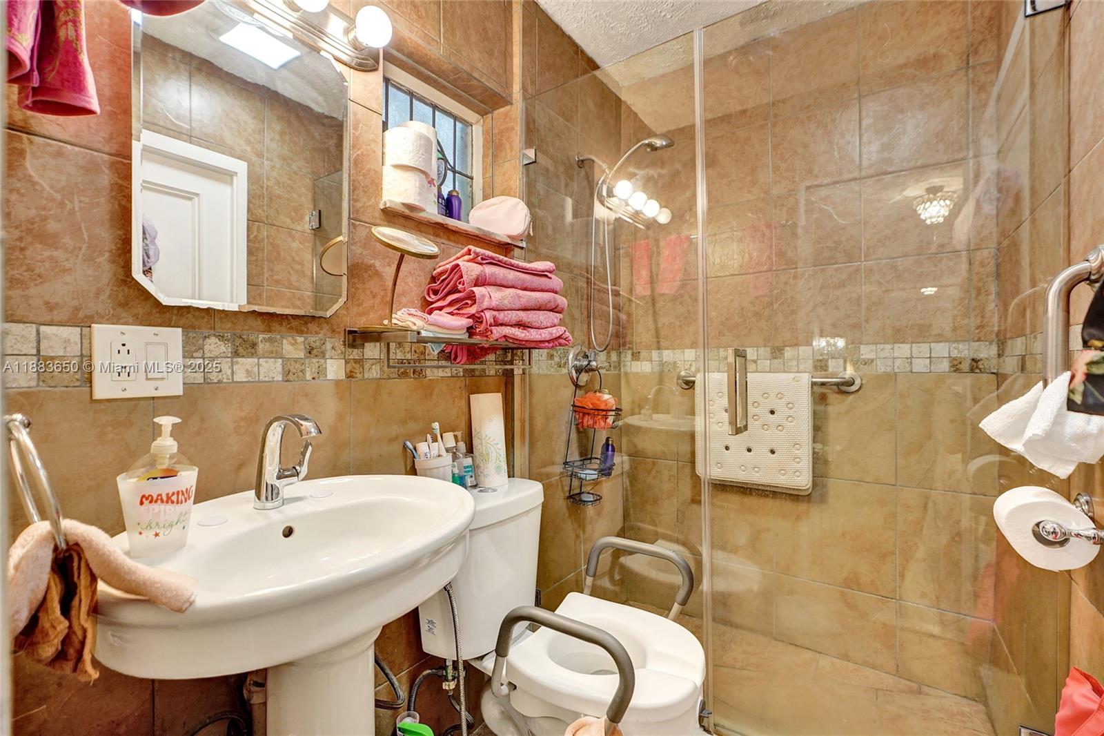 9156 Northwest 3rd Avenue Miami, FL 33150 - Photo 17 of 26 a bathroom with a sink mirror and toilet