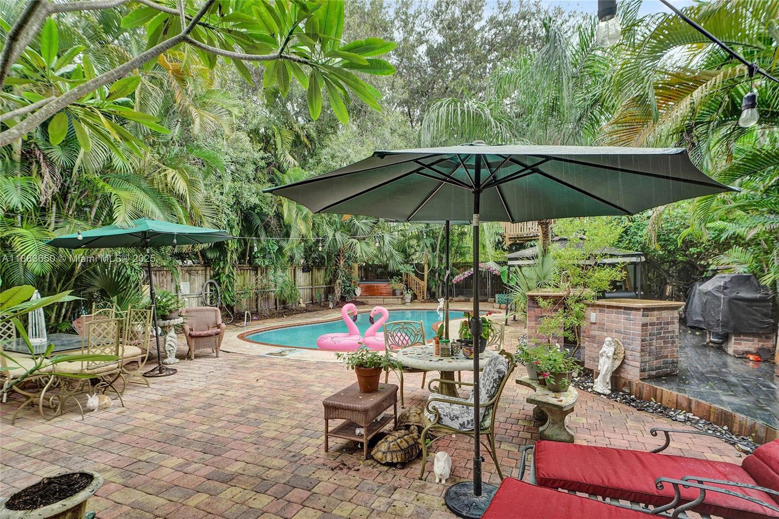 9156 Northwest 3rd Avenue Miami, FL 33150 - Photo 19 of 26 an outdoor space with furniture and umbrella