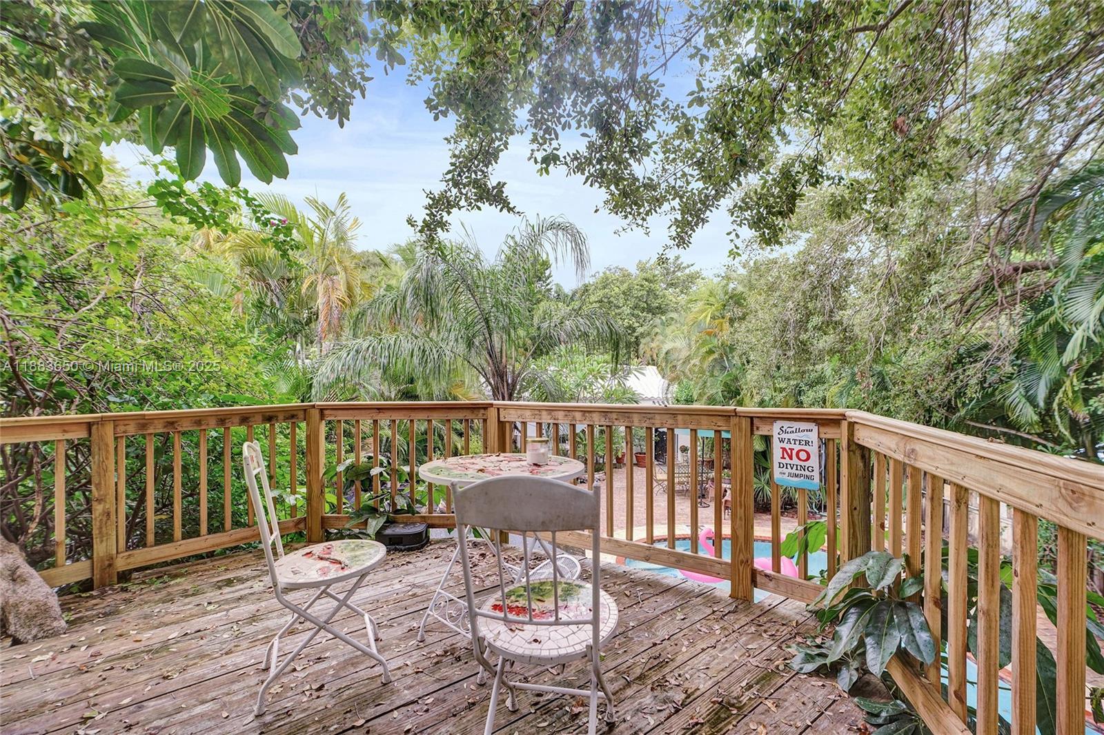 9156 Northwest 3rd Avenue Miami, FL 33150 - Photo 23 of 26 a balcony with wooden floor and outdoor seating