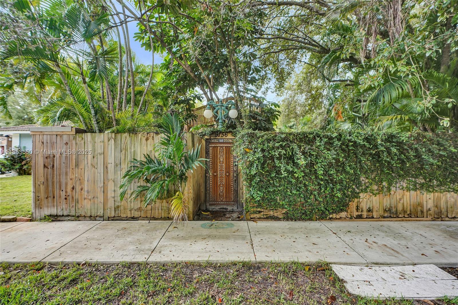 9156 Northwest 3rd Avenue Miami, FL 33150 - Photo 25 of 26 a wooden fence with trees