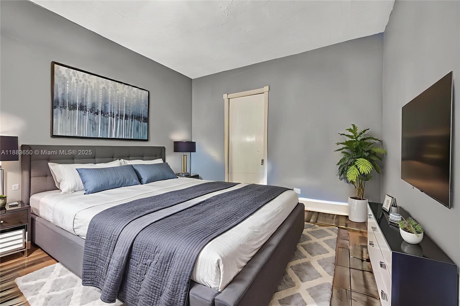 9156 Northwest 3rd Avenue Miami, FL 33150 - Photo 5 of 26 a bedroom with a bed and a flat screen tv