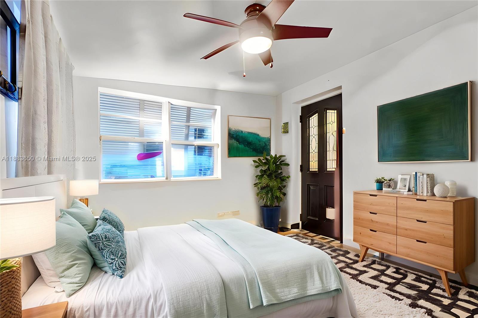 9156 Northwest 3rd Avenue Miami, FL 33150 - Photo 8 of 26 a bedroom with a bed and a flat screen tv