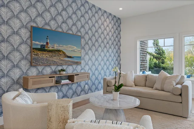 a living room with furniture and a floor to ceiling window