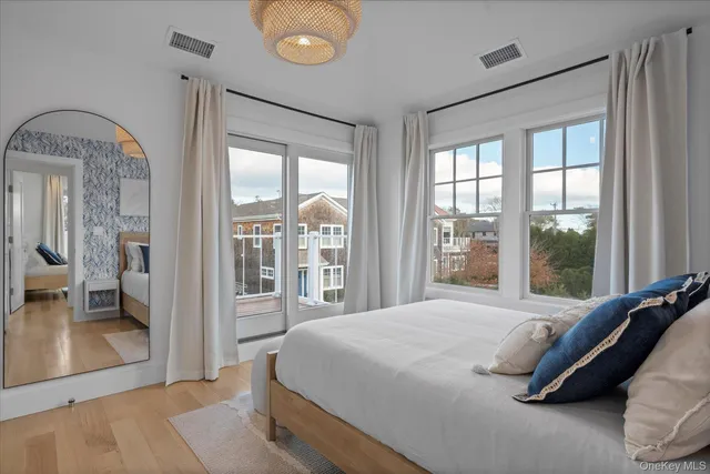 a bedroom with a large bed and a large window