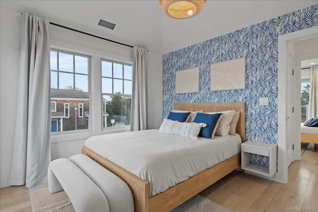 a bedroom with a bed and a large window