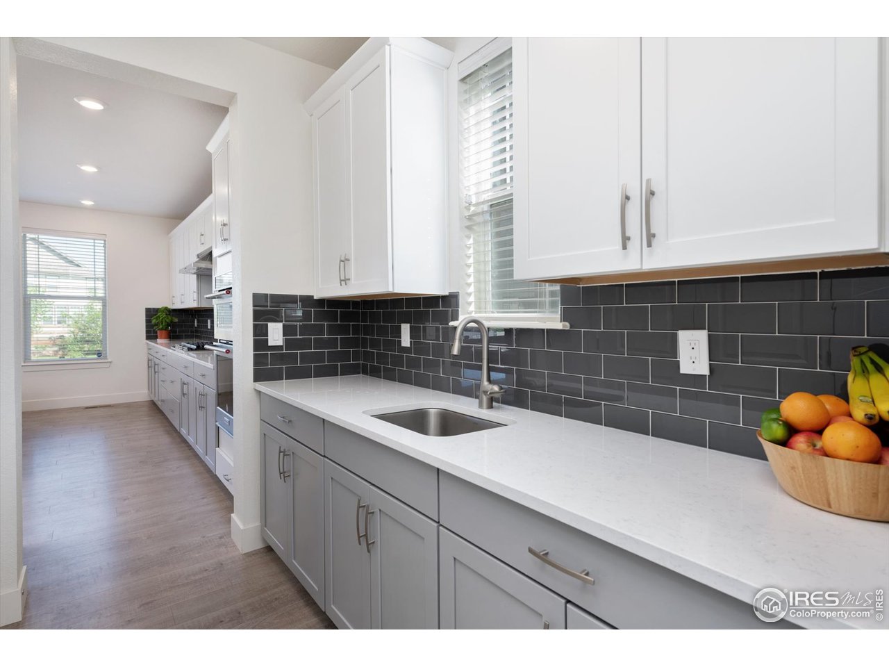 2159 Summerlin Lane Longmont, CO 80503 - Photo 13 of 37 a kitchen with a sink and cabinets