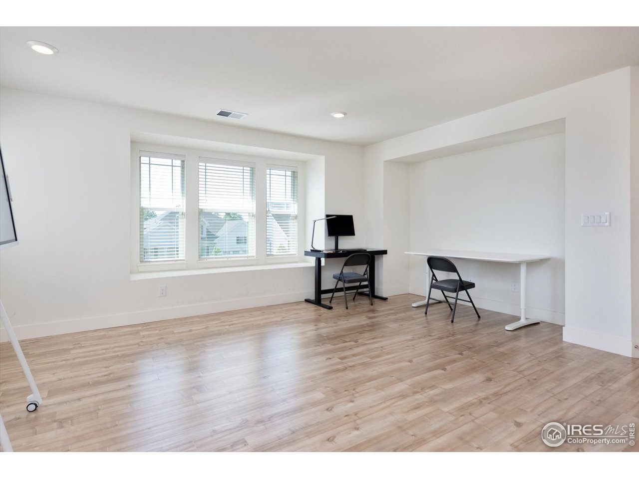 2159 Summerlin Lane Longmont, CO 80503 - Photo 18 of 37 a view of an empty room with window and wooden floor