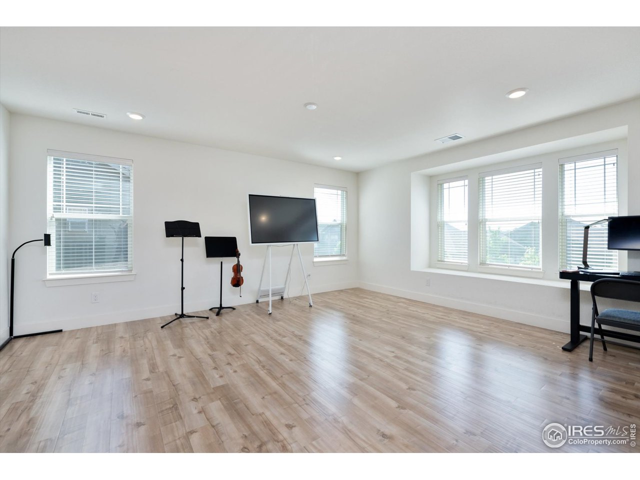 2159 Summerlin Lane Longmont, CO 80503 - Photo 19 of 37 a view of an empty room with a window and wooden floor
