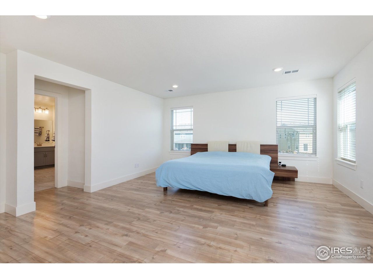 2159 Summerlin Lane Longmont, CO 80503 - Photo 21 of 37 a bedroom with a bed and wooden floor