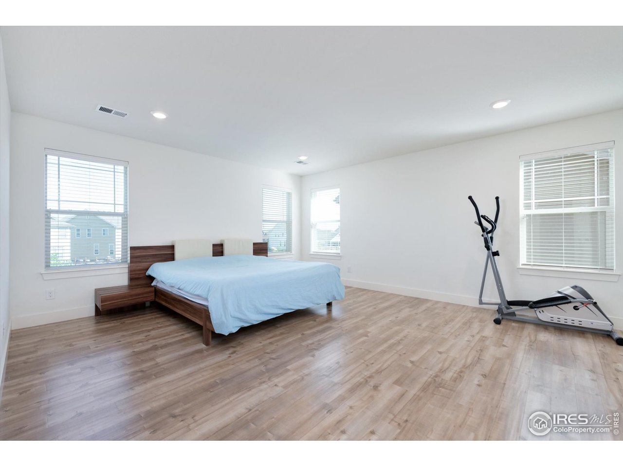 2159 Summerlin Lane Longmont, CO 80503 - Photo 22 of 37 a bedroom with a bed and wooden floor