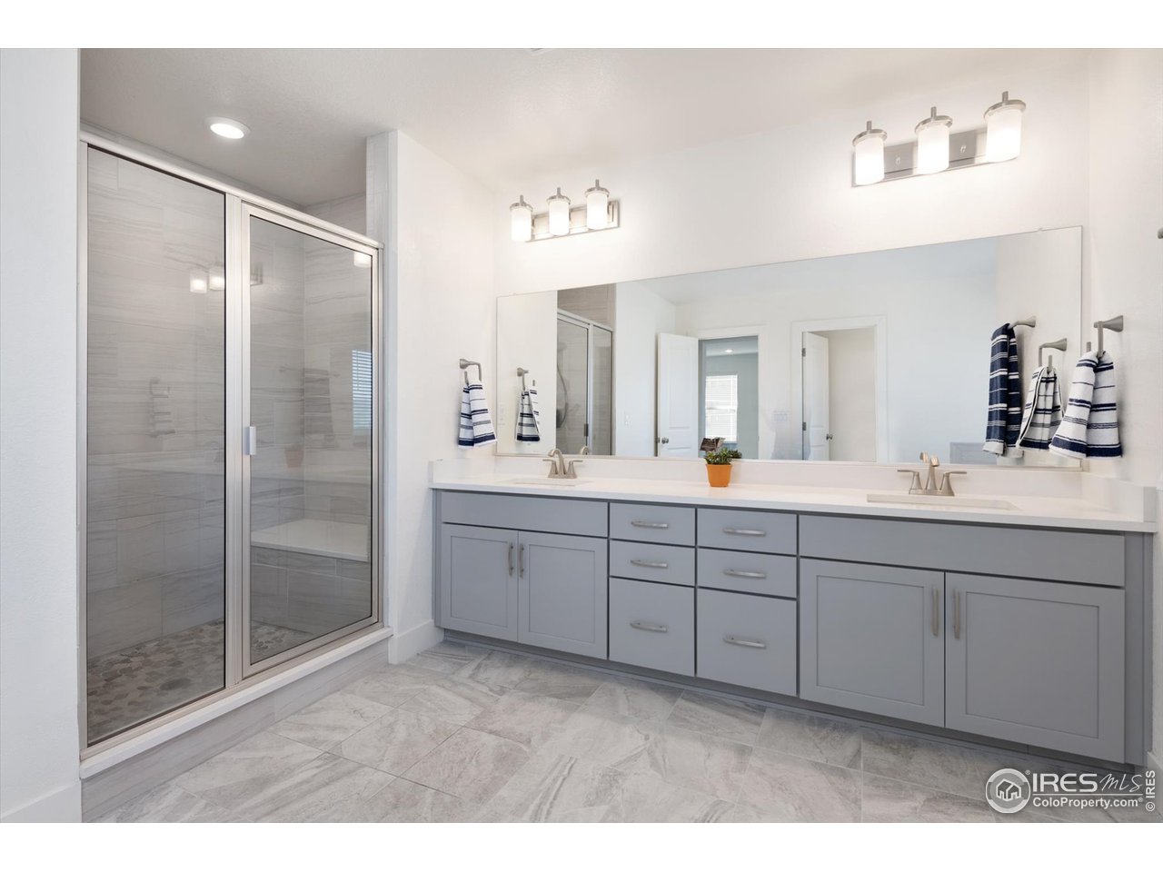 2159 Summerlin Lane Longmont, CO 80503 - Photo 25 of 37 a bathroom with a double vanity sink mirror and shower
