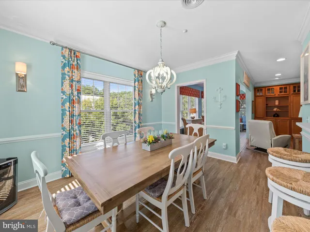 a view of a dining room with furniture wooden floor and chandelier