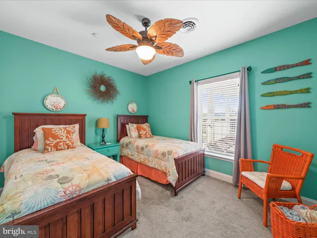 a bedroom with two beds and a chandelier