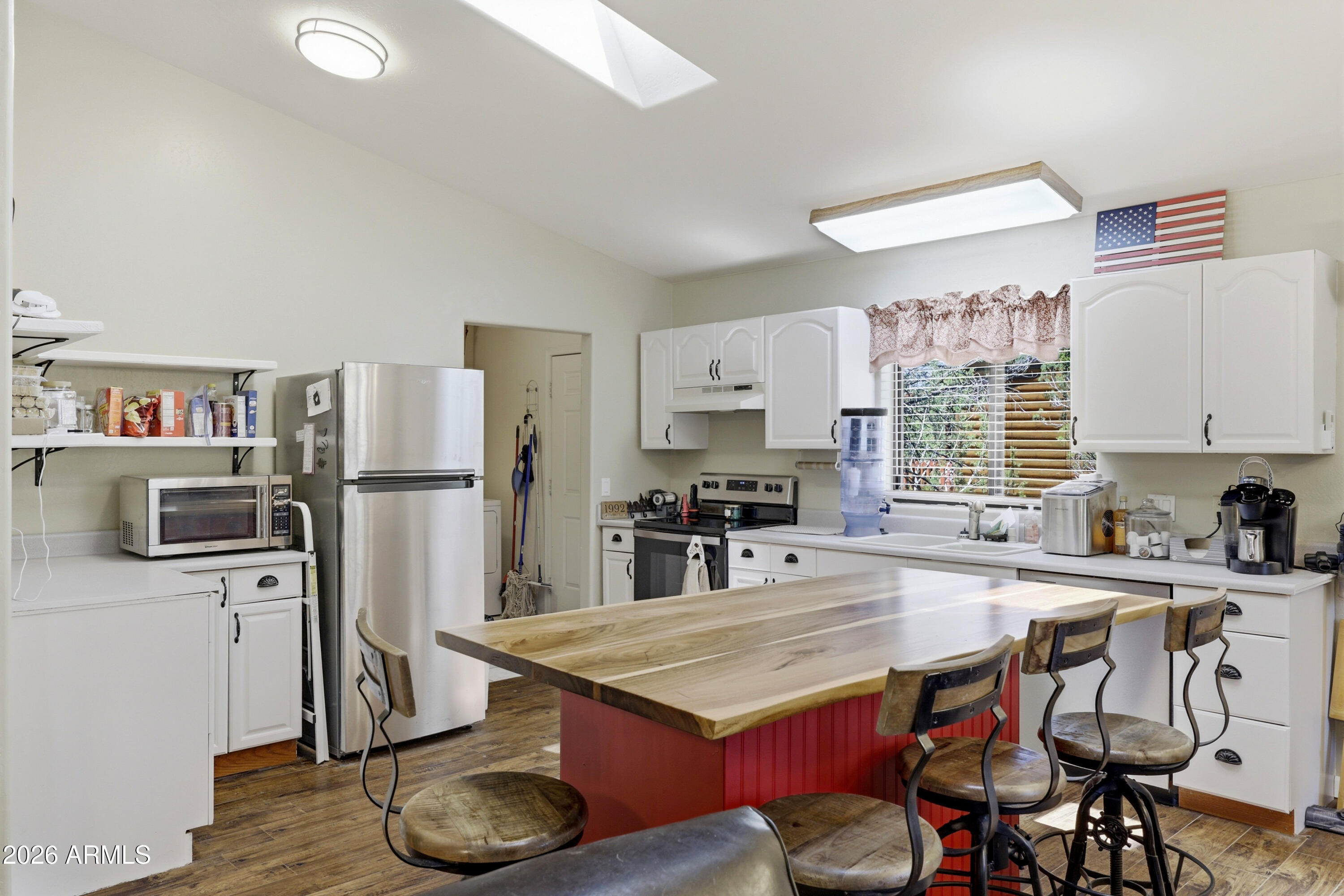 1992 Red Deer Run Overgaard, AZ 85933 - Photo 11 of 35 a kitchen with stainless steel appliances granite countertop a sink stove and refrigerator