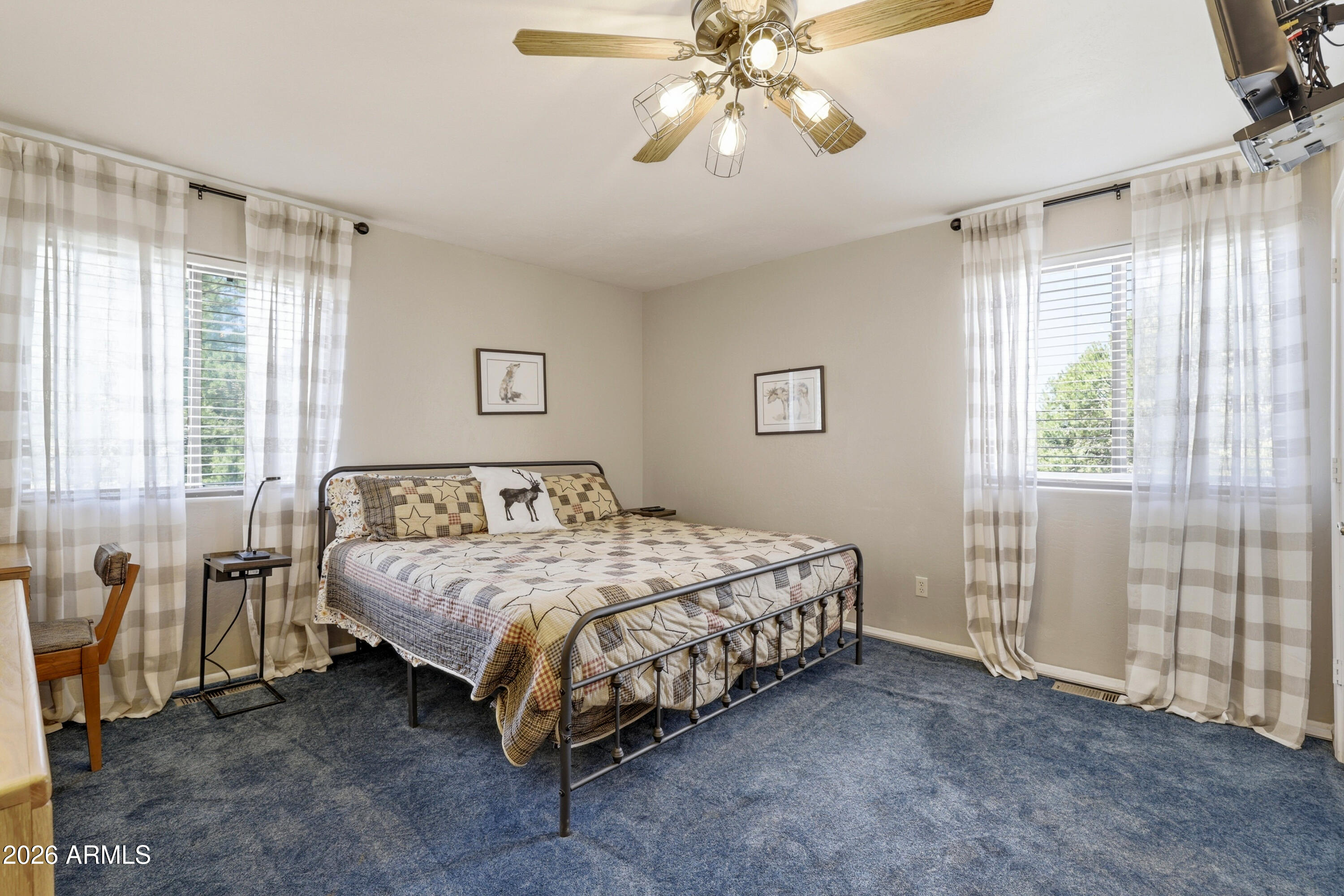 1992 Red Deer Run Overgaard, AZ 85933 - Photo 15 of 35 a bedroom with a bed and a chandelier