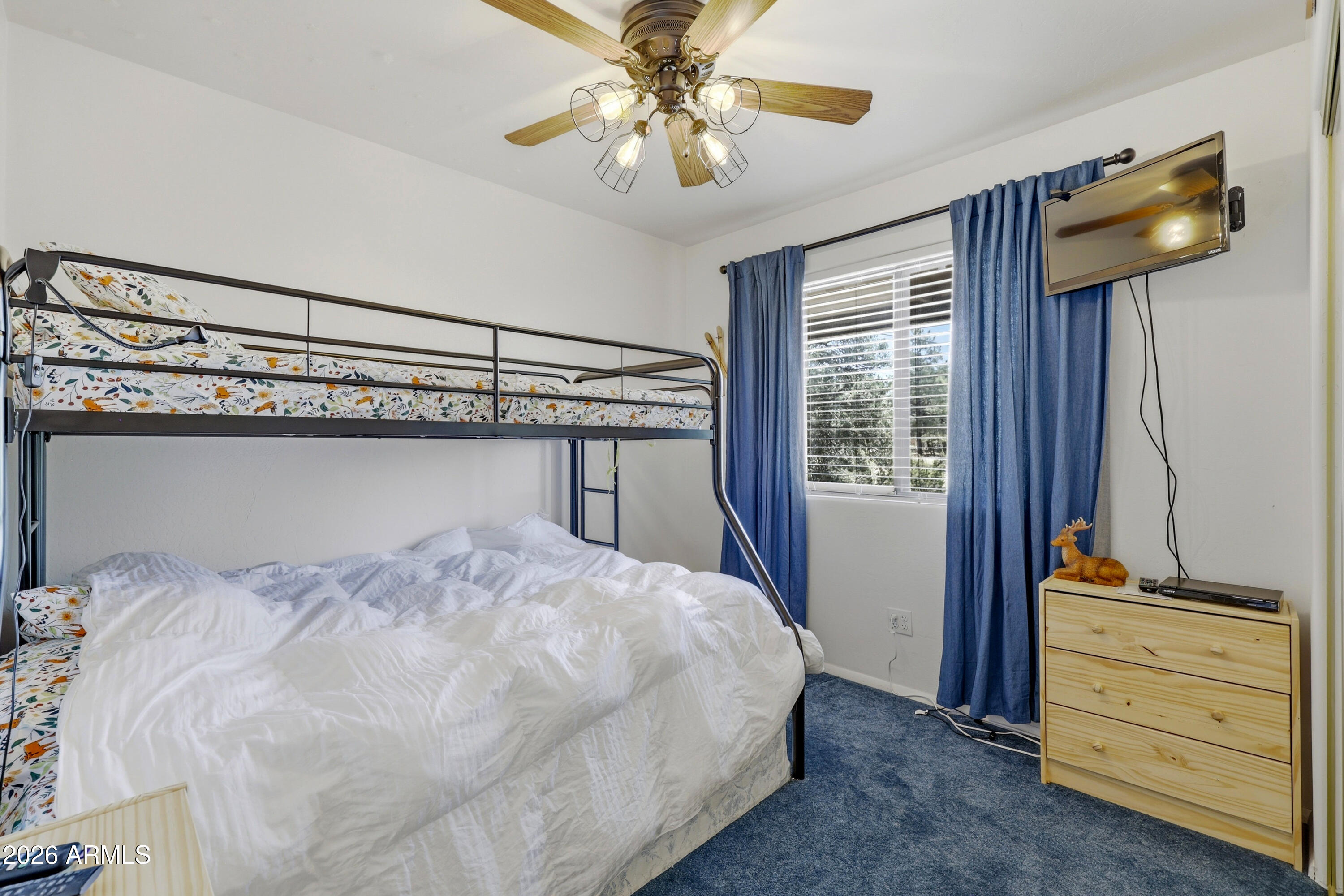 1992 Red Deer Run Overgaard, AZ 85933 - Photo 19 of 35 a bedroom with a bed and a dresser