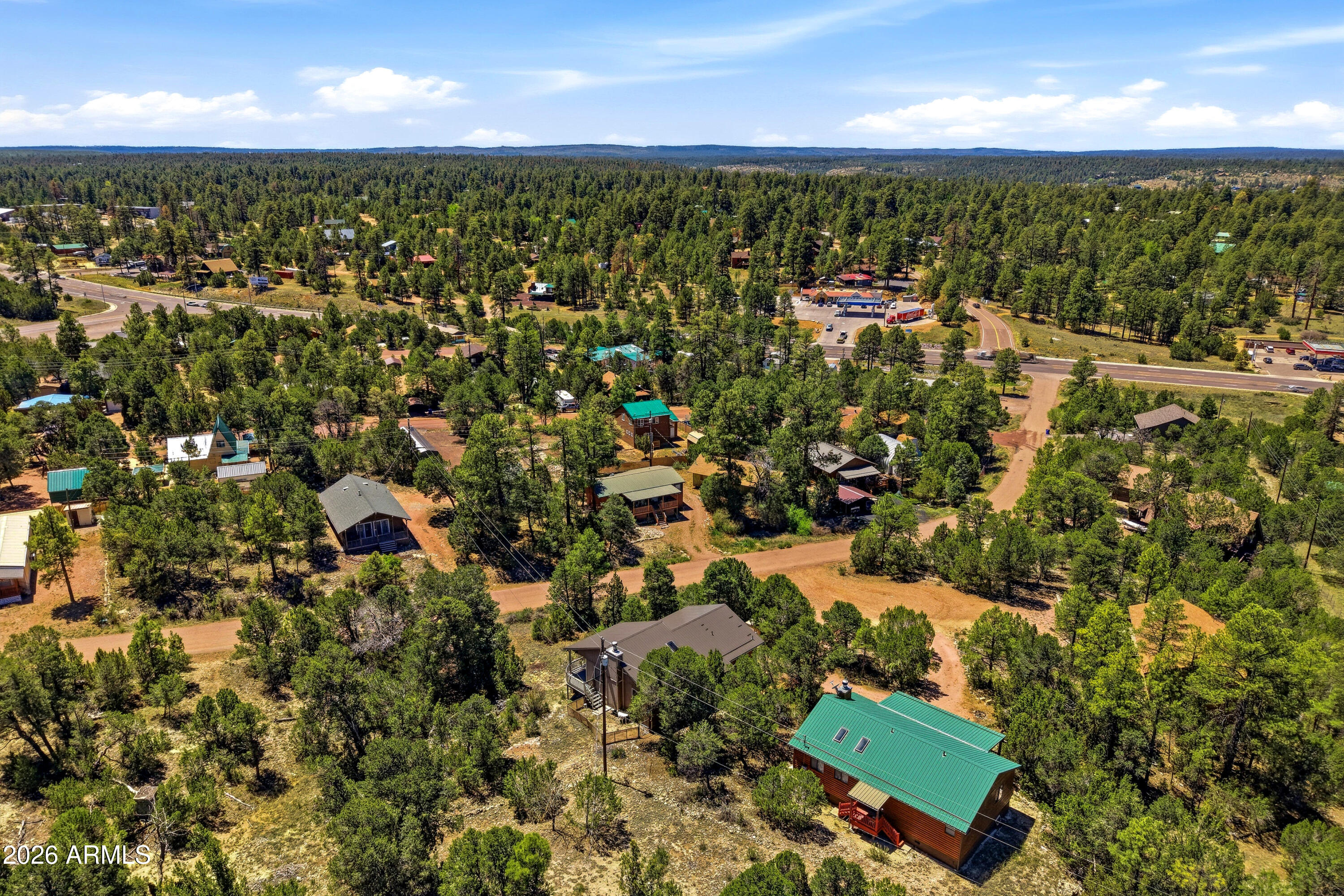 1992 Red Deer Run Overgaard, AZ 85933 - Photo 32 of 35 an aerial view of residential houses with outdoor space and trees