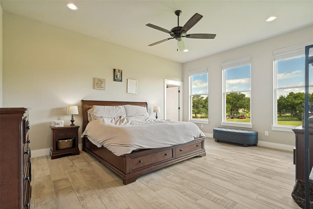 6913 Veal Station Road Weatherford, TX 76085 - Photo 15 of 31 Spacious room featuring light wood-finish flooring, three large windows, a ceiling fan with integrated lighting, and recessed ceiling lights