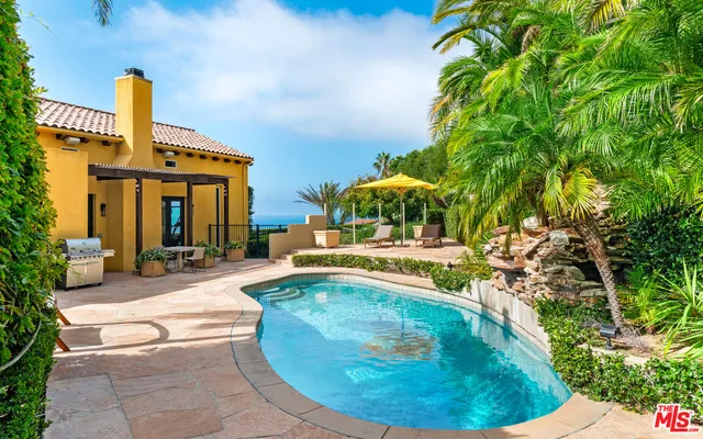 a view of a swimming pool with a patio