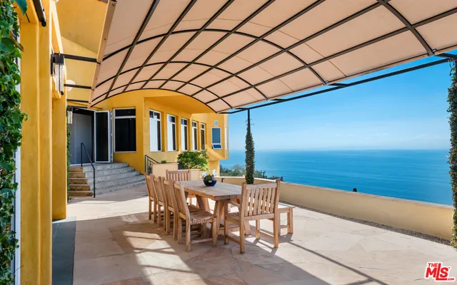 a view of a patio with table and chairs and potted plants