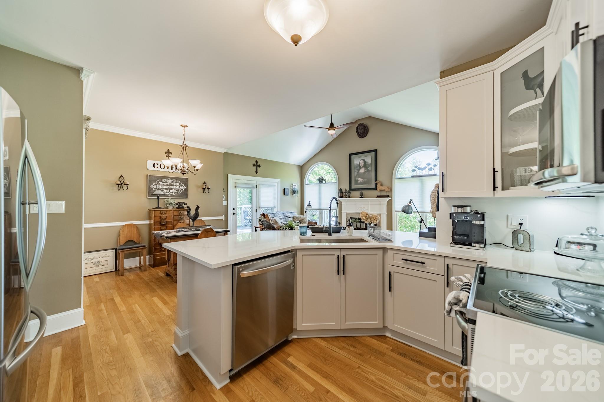 11043 Seven Coves Drive Tega Cay, SC 29708 - Photo 25 of 45 a kitchen with a sink cabinets and wooden floor