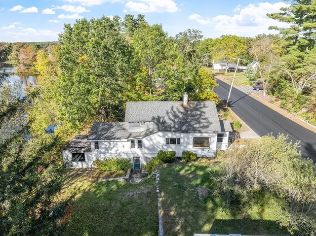 an aerial view of a house with a yard