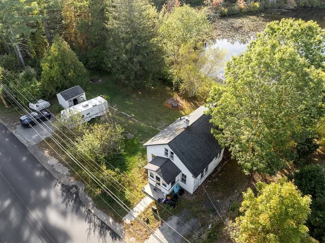 a view of a forest with trees and houses