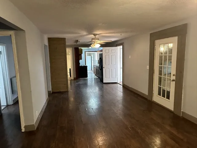 a view of a hallway with wooden floor