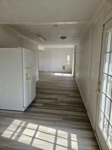 a view of a hallway view with wooden floor and staircase